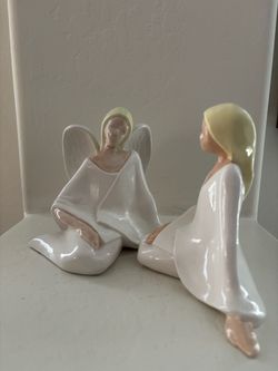 Pair of Ceramic angel and postulant figurines