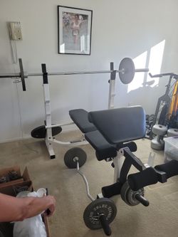 Powerhouse 300 lb weight bench for sale. Has adjustable bench and arm/ leg platform.  Comes with curling bar.