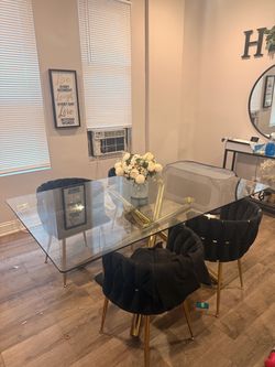 Glass table with blacked tufted chairs
