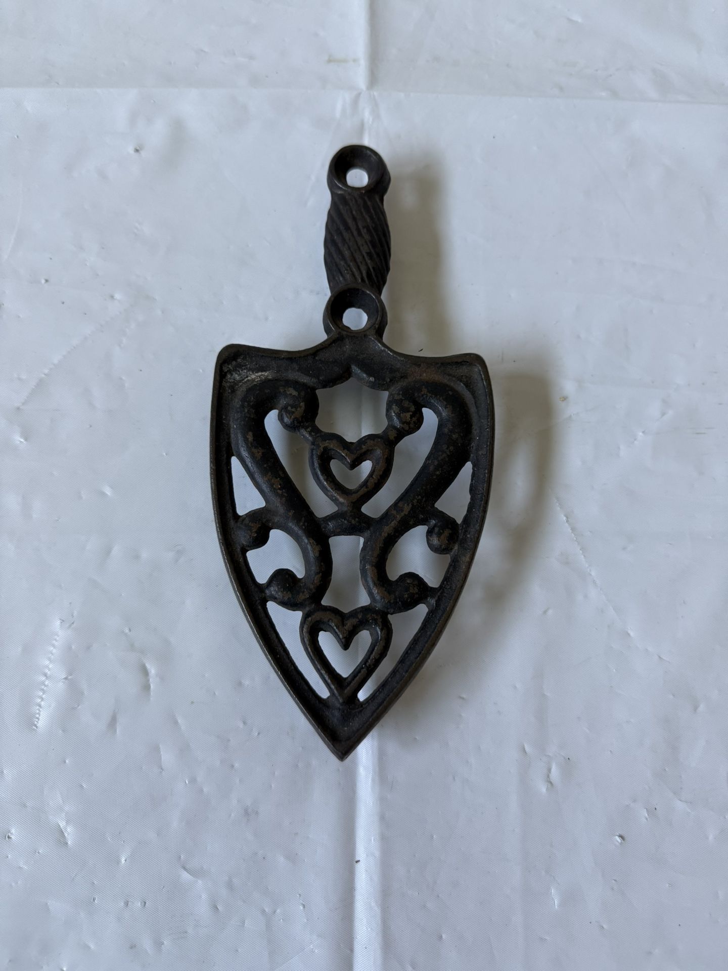 Vintage Black Cast Iron Trivet with a Double Heart and Scrolls Pattern