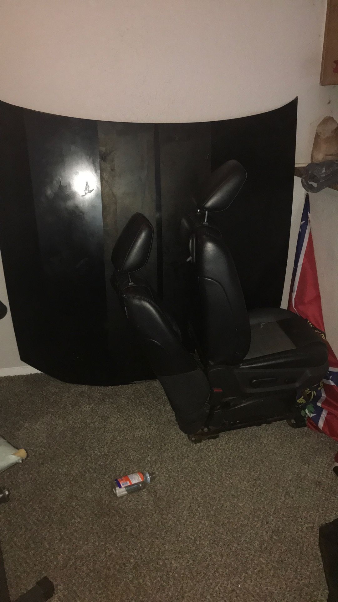 Two seats for a car and a car hood stop