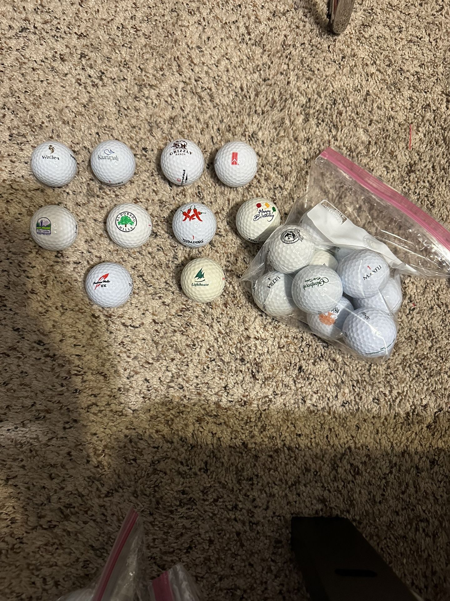 Name brand golf balls with random logos (Courses, restaurants, slogans, brands, etc.)