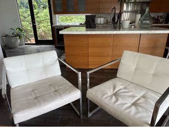 2 white leather chairs