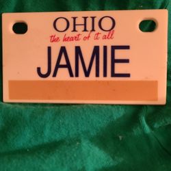 Small plastic license plate "JAMIE" on it. 4x6