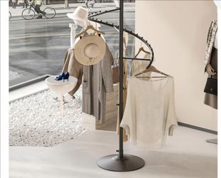 HKAIKZO freestanding rotating clothing rack.