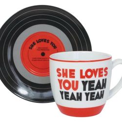 For sale brand new and in original box The Beatles ceramic cup and saucer “She loves you yeah yeah yeah”.