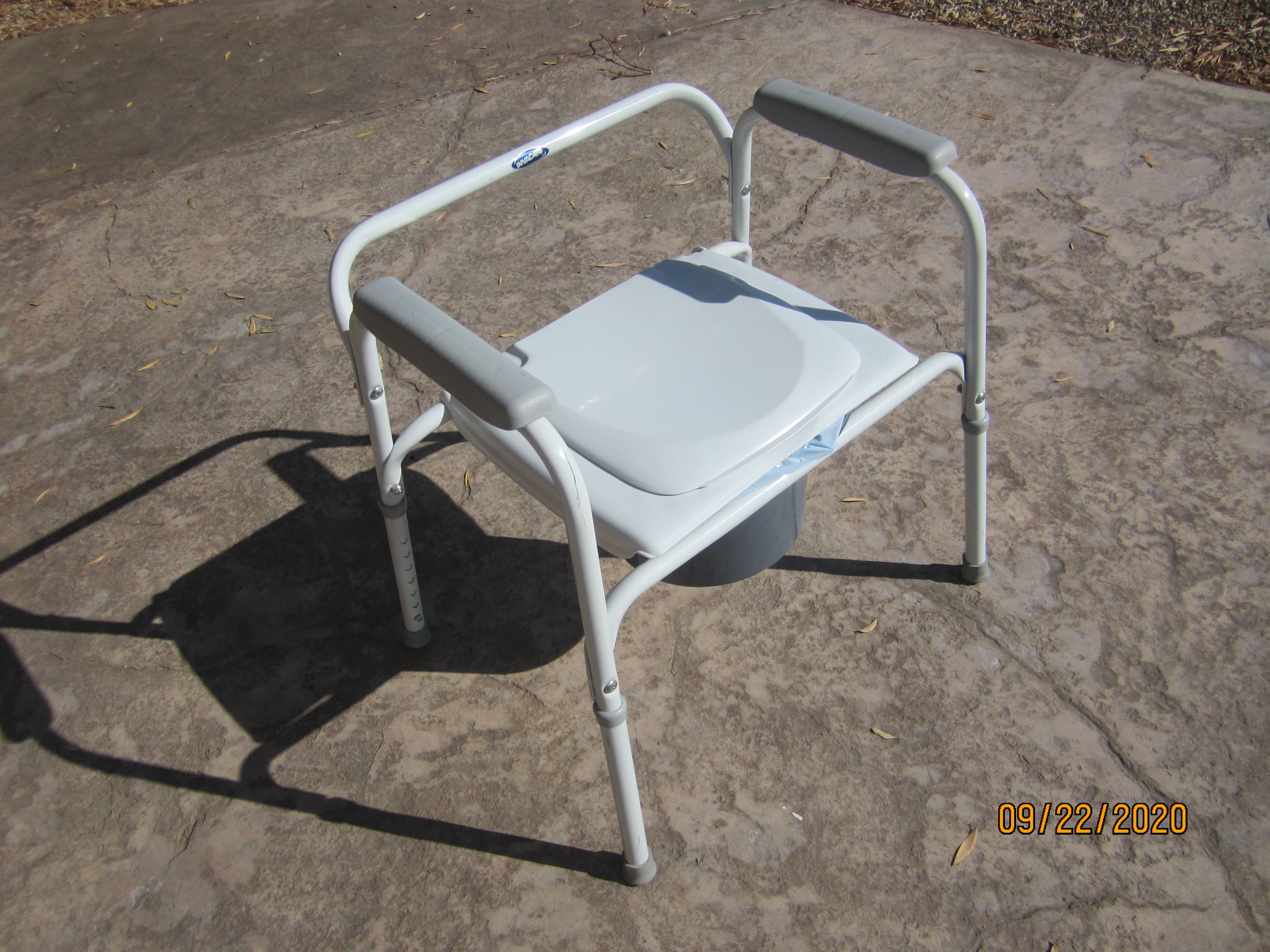 Portable toilet or bedside commode by Invacare and box of 72 liners