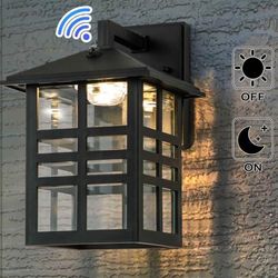 1-Light Black Dust To Dawn LED Outdoor Wall Lantern Sconce With Clear Glass Shade.