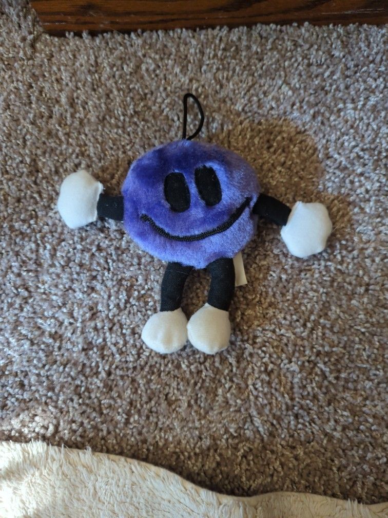 Smiley Face Plush Purple with loop for hanging.