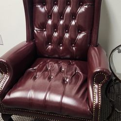 Elegant traditional wingback chair, burgandy color.