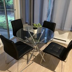 Beautiful Round Glass Dining Table and Black Chairs