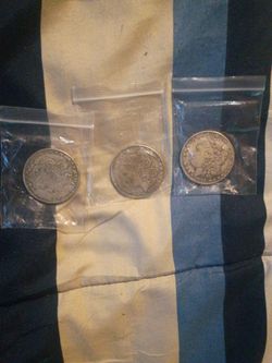 Three silver Morgan Stanley silver dollars