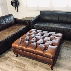Tufted Genuine Leather Ottoman, Dark Brown, decorative base legs with wheels. Approx 40" x 40" x 18".  In Great Condition.
