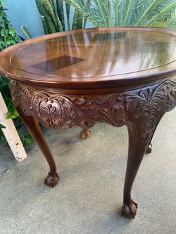 A mahogany Chippendale-style round occasional table with carved apron