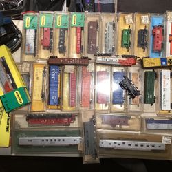 4 Vintage “N” Scale train units, 28 Various Cars. Track on 3’x4’ track Layout board and related accessories / track pieces. 