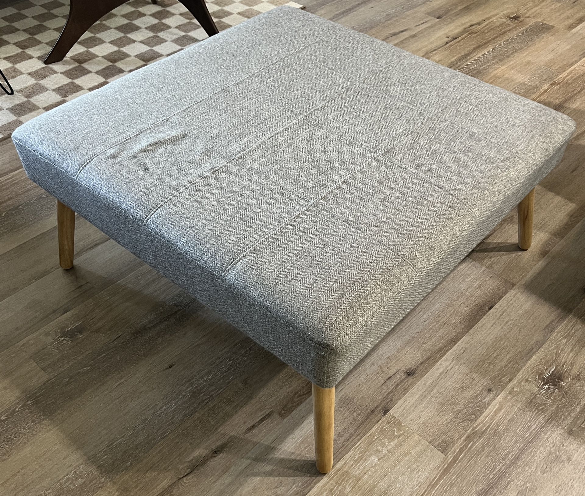 Square grey ottoman/coffee table with wood legs   