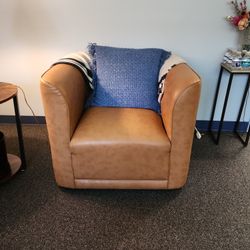 Light Brown Leather Chair With Throw And Pillow