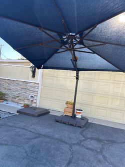 Brand new 10’ cantilever umbrella with sunbrella fabric plus complete base still in the original box. $450 firm