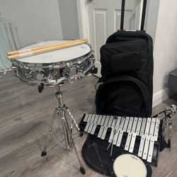 percussion kit (snare drum, bells, sticks, practice pad, stand, and rolling bag)