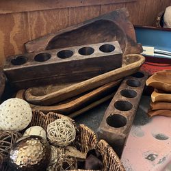 A collection of antique or vintage wooden sugar molds and decorative bowls.