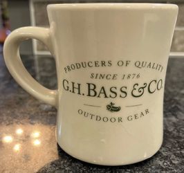 G.H. Bass & Co. ceramic mug with classic green logo. Smooth glazed finish for easy cleaning. Simple, timeless styling for daily use. Great for coffee 