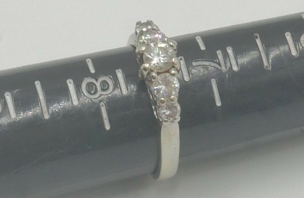 14KT WHITE GOLD ANNIVERSARY BAND SIZE 7.5 3.8 GRAMS WITH 5 DIAMONDS APPROXIMATE CENTER ROUND DIAMOND 0.30 0.35PTS SI2 H; 2 SIDE DIAMONDS 0.16 0.18