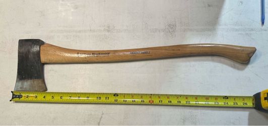 25”vintage Village Blacksmith single-bit axe with a curved hickory wood handle.