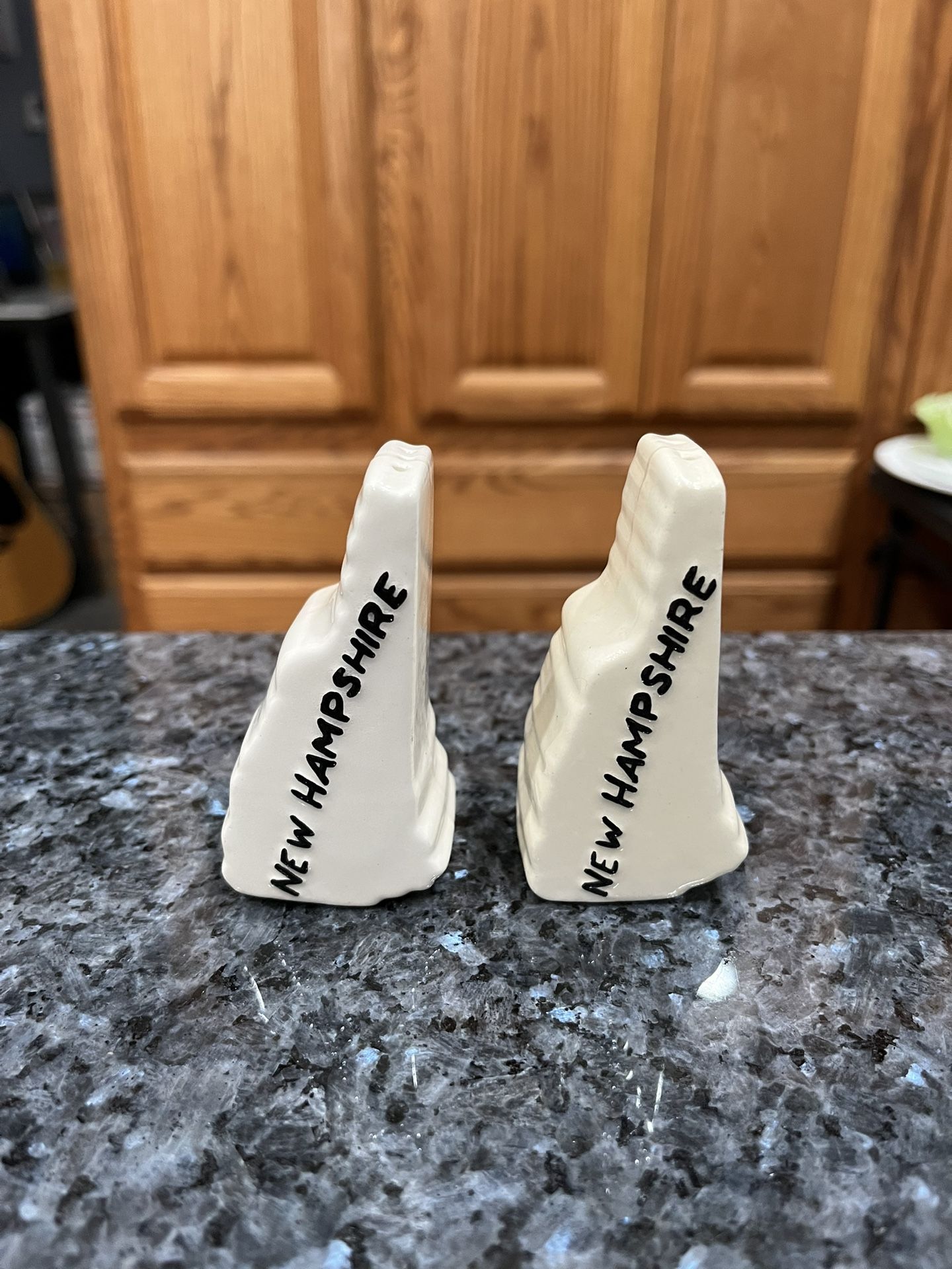Vintage Ceramic New Hampshire Shaped Pair of Salt and Pepper Shakers. Preowned no stoppers. Size approximately 3 inches tall. Preowned.