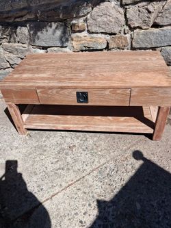 Oak finish table. 55 L 23 W 18 H. Sold shelf with pull handle.