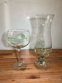 Clear glass tumbler featuring the iconic green Pat O'Brien's of New Orleans logo.