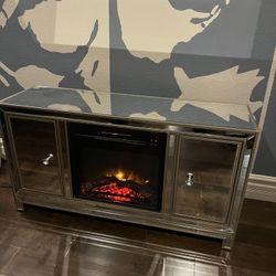 Mirrored Tv console Holds up to 65” Tv with built in electric fireplace 