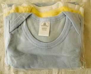 The package contains 3 new shirts in 3 colors, size 3-6 months.