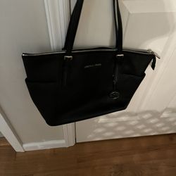Stylish black handbag by Michael Kors.