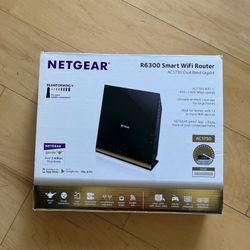 A NetGear R6300 Smart WIFI Router AC1750 includes wireless adapter/cords/cables/