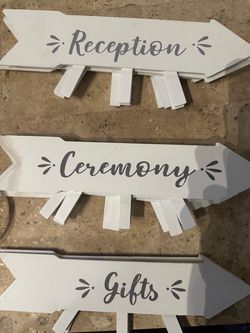 10 white wooden arrow-shaped directional signs