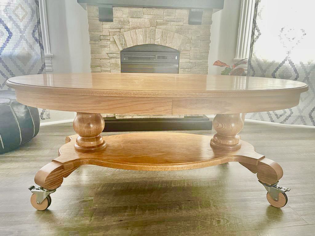 Golden Oak oval table with designer wooden casters