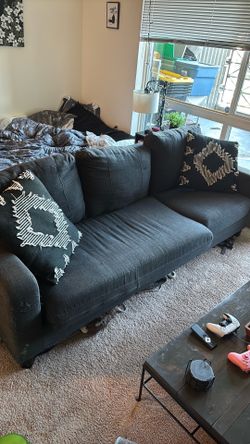 Dark grey couch with pillows