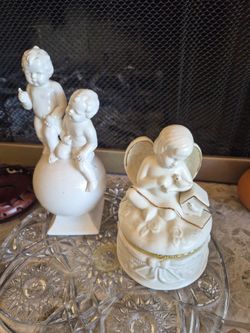 2 white decorative ceramic angels