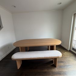 Catania oval dining table with two benches.