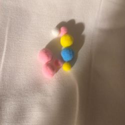 Charms To Put Something In. There Are Yellow Blue And White 