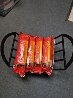 Black metal fire log holder with 4 3hour fire log