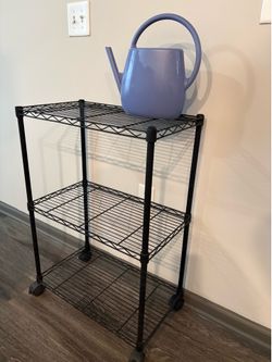 Modern blue watering can