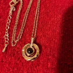20” Goldtone Necklace With Clock Pendant With Cubic Zirconia And Small Ruby Stone..