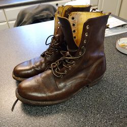 FRYE. WORK BOOTS. SIZE. 10.5. SOLES LIKE  NEW. DOG CHEWED THE PULL ON TABS OFF  BUT U NEVER SEE THAT WITH PANTS COVERING. BOOT TOP.    LOL. 