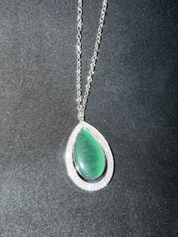 Paparazzi necklace featuring a large green stone pendant with rhinestones on a silver tone chain