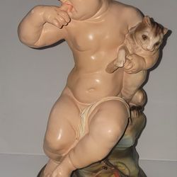 SITTING BOY CARRING A CAT