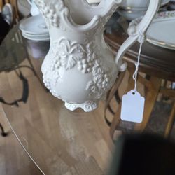 : This particular piece features a raised relief design of grapes and vines, which is a common motif in vintage ceramics. 