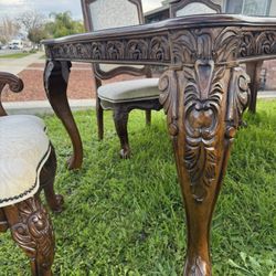 Ornately carved dining table + 6 chairs