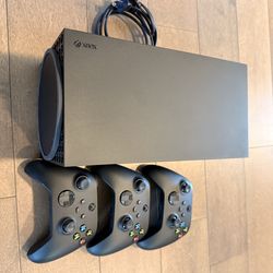 Xbox Series X with three controllers