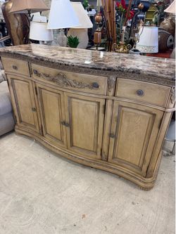 Cindy Crawford traditional style buffet with a bisque finish and a dark stone top
